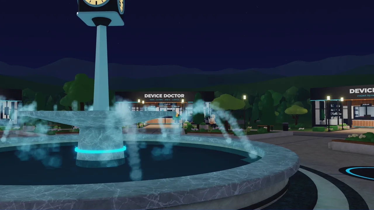 The plaza fountain and clock tower at night