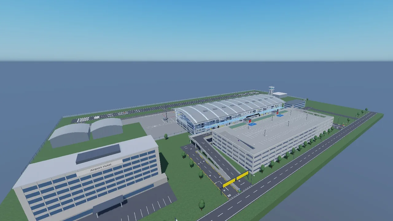 Aerial view of the airport from the landside: hotel, approach road, multi-storey car park and the curved-roof terminal