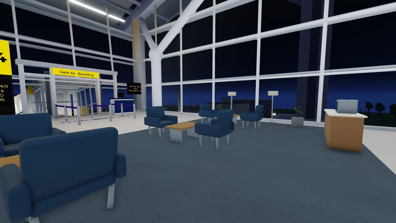 Passenger lounge with armchairs beside the gate windows at night